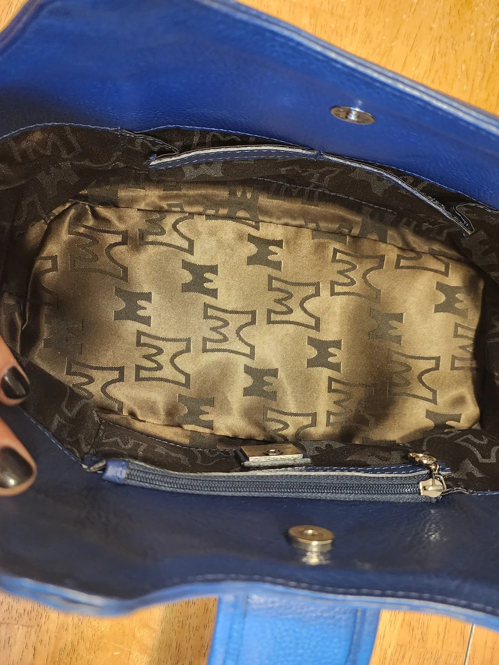 Metrocity leather handbag in white and navy with a quilted monogram pattern